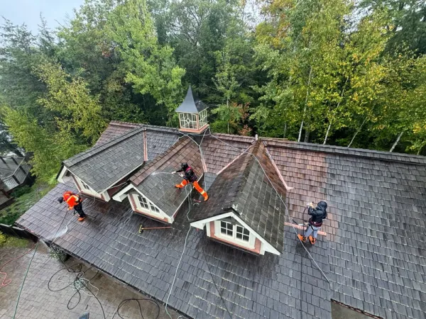 Brite team pressure washing a roof in Muskoka