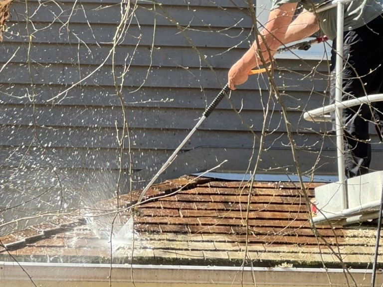 Pressure washing a cedar shake roof in Muskoka