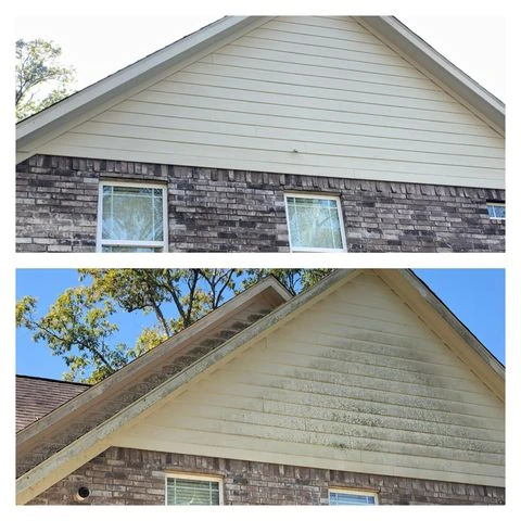 Close-up of siding being cleaned with soft washing techniques on a Muskoka home to restore its original look.
